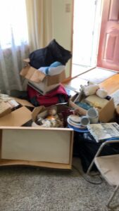 A room filled with boxes, trash bags, and various household items awaiting junk removal by HaulPros in Erie, PA.