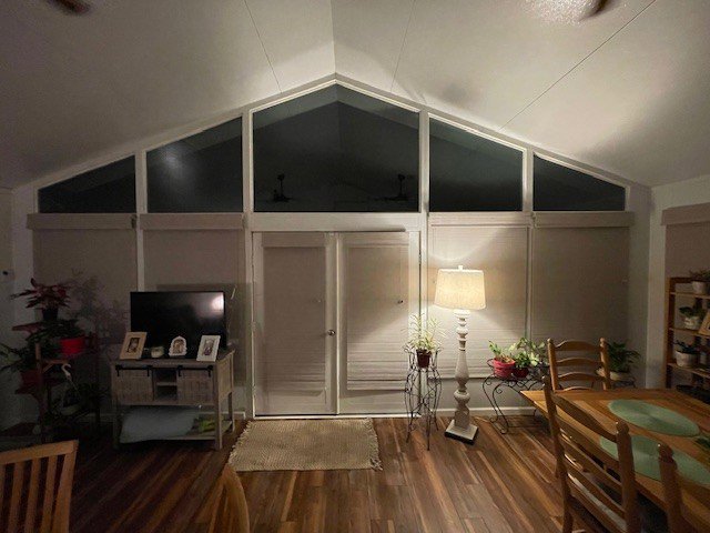 An interior room with high vaulted ceilings and large windows, a construction project by NRG Industries in Tallahassee, FL.