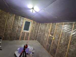 A room under construction with insulation and drywall being installed by Hawk Handyman Services in West Fargo, ND