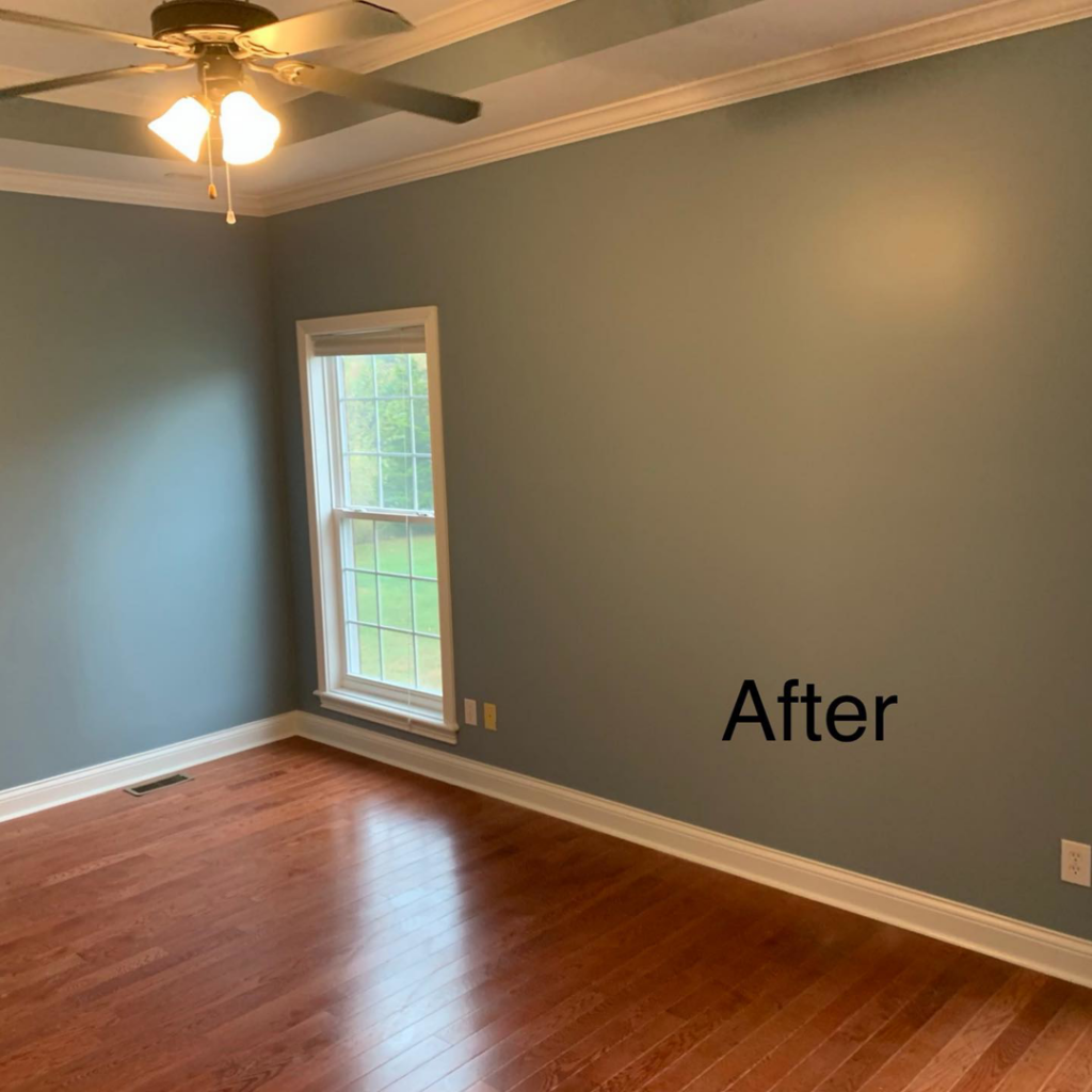 An "After" photo of a room with newly painted blue-grey walls and hardwood floors by Wilder Painting, LLC in Quincy, MA