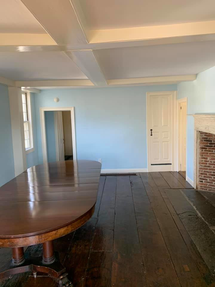 A room featuring light blue painted walls and white ceiling beams, completed by D'Costa Finish Painting in Fall River, MA.