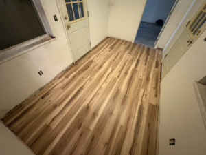 A room featuring newly installed wood flooring, a handyman service provided by CJ Flooring LLC in Flat Rock, MI.