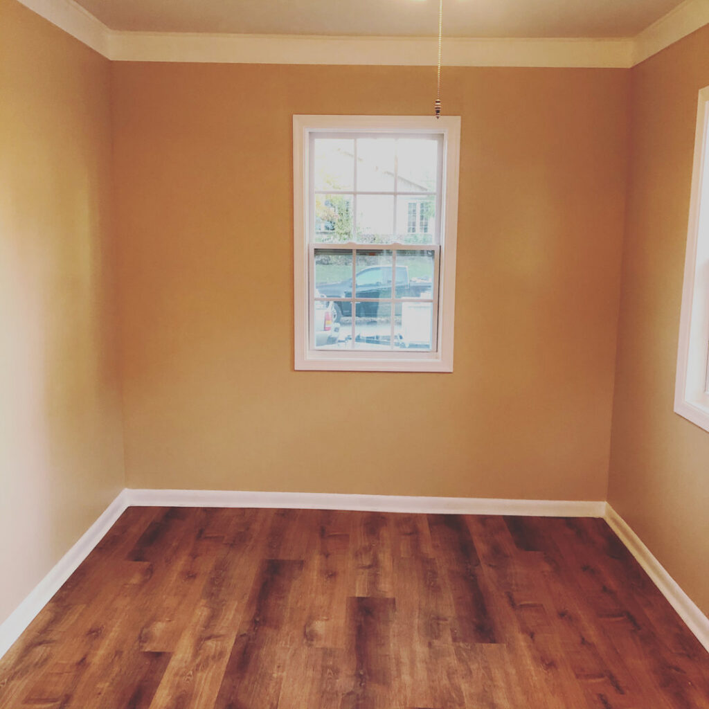 A freshly painted room with new laminate flooring installed by DG Maintenance Services LLC in Wilmington, DE
