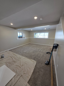 A room remodeling project with new carpet, windows, and recessed lighting by Rosenthal Remodeling in Milton, WI.