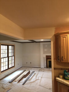 Room renovation in progress with exposed beams and new window trim by Farnsworth Interiors Drywall and Plaster in Akron, OH