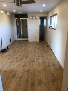 A completed room renovation with new flooring and lighting by J & J Cavallo Custom, LLLP in Yakima, WA