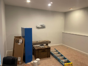 A room undergoing renovation with a ladder and supplies by Norbe's Home Solutions LLC in Lenexa, KS.