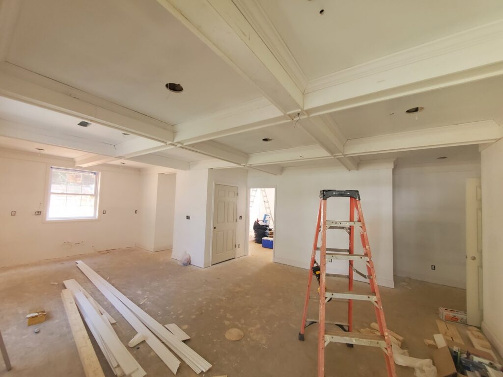 Room renovation in progress with newly painted walls, unfinished floor, and a ladder, handled by GCI Services, Inc. in Simpsonville, SC