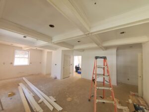 Room renovation in progress with newly painted walls, unfinished floor, and a ladder, handled by GCI Services, Inc. in Simpsonville, SC