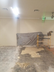 A room undergoing renovation with scaffolding and a tarp by United Contracting, LLC in Lexington, KY