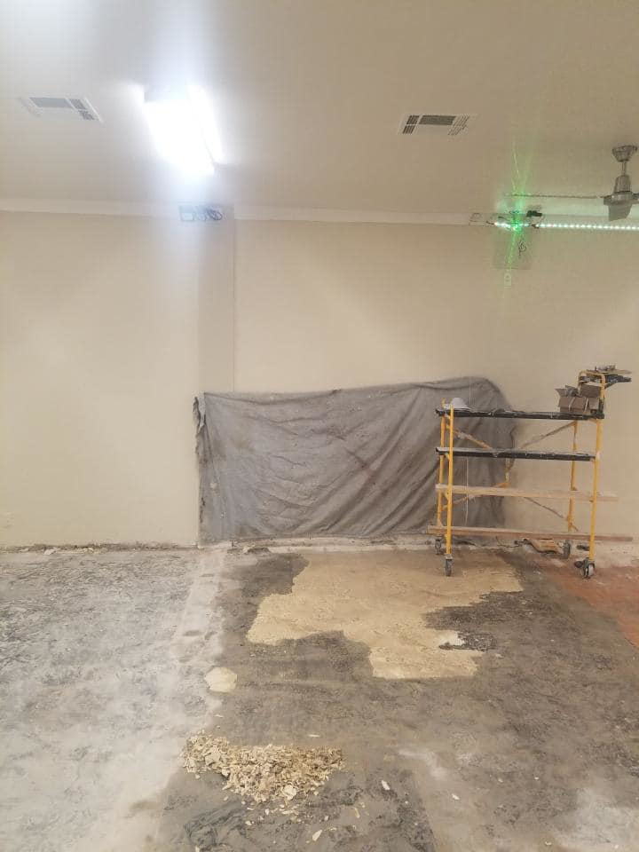 A room undergoing renovation with scaffolding and a tarp by United Contracting, LLC in Lexington, KY