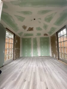 A room under construction with new drywall and flooring installed by Elite Handyman & Remodeling in Dallas, TX.