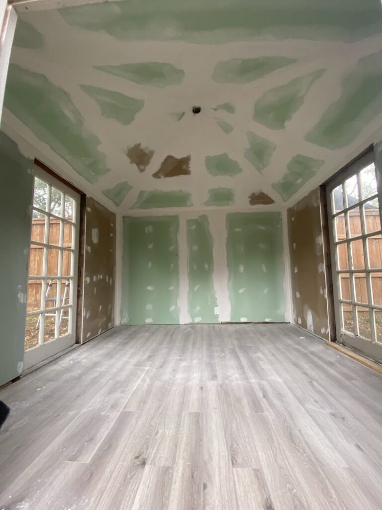 A room under construction with new drywall and flooring installed by Elite Handyman & Remodeling in Dallas, TX.