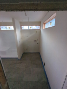 A room under construction with new walls and flooring by Becker Custom Construction - pdx in Oak Grove, OR.