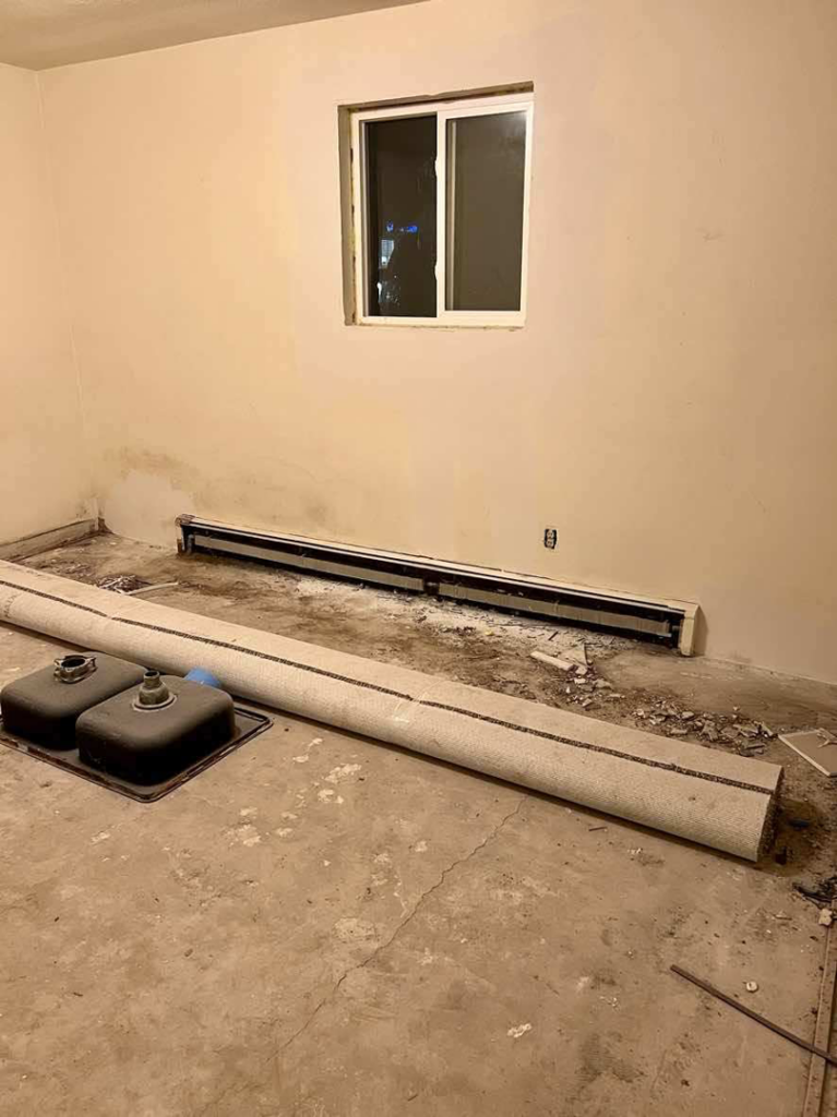 A room undergoing renovation with old carpet removed and fixtures awaiting installation by Get It Done in Sioux Falls, SD.