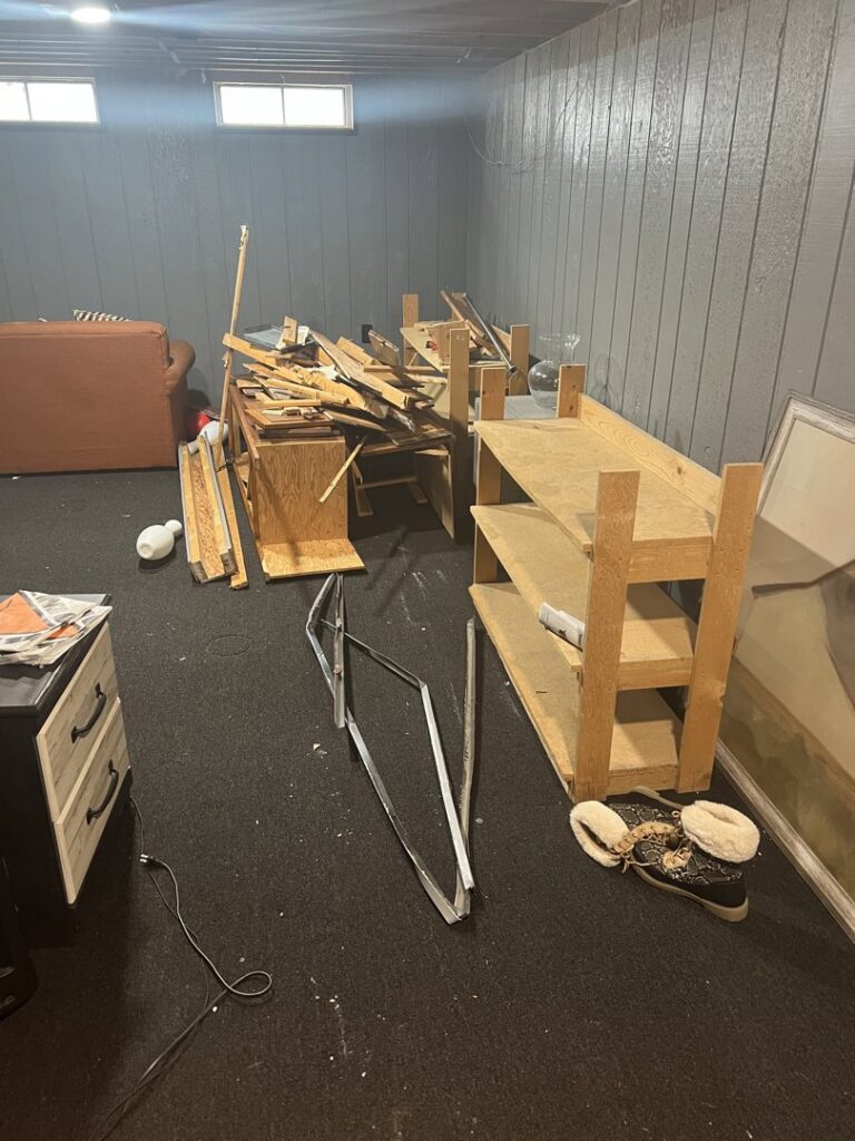A room with disassembled wooden furniture and metal pieces on the floor, ready for removal by Prestige Junk Removal & Hauling in Detroit, MI.