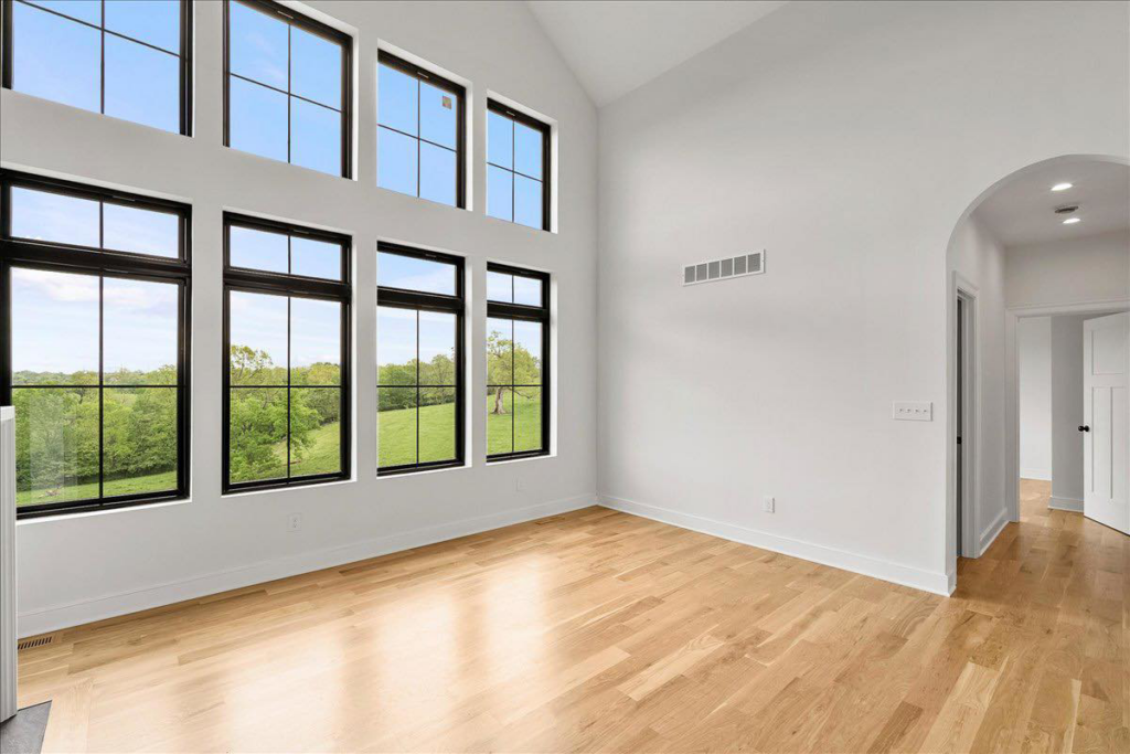 Room with large windows and pristine light hardwood floors by WoodHaven Floor Refinishing in Georgetown, KY.