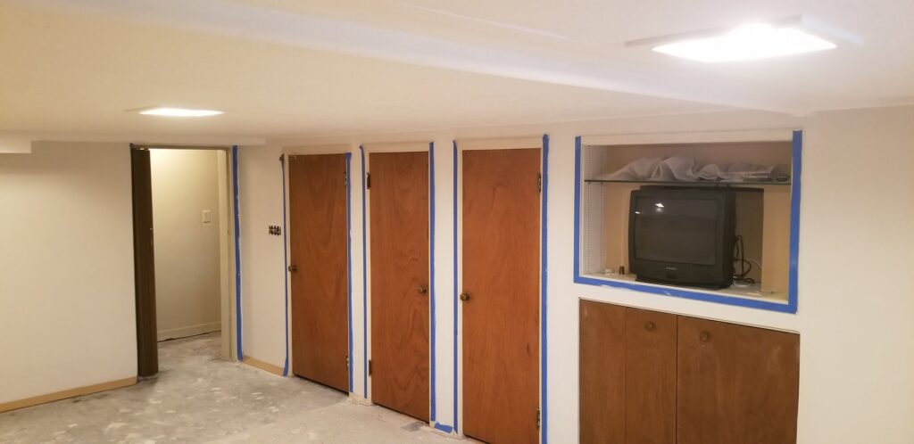 A renovated room featuring multiple doors and custom built-in shelving, completed by Branham Handyman in Salt Lake City, UT