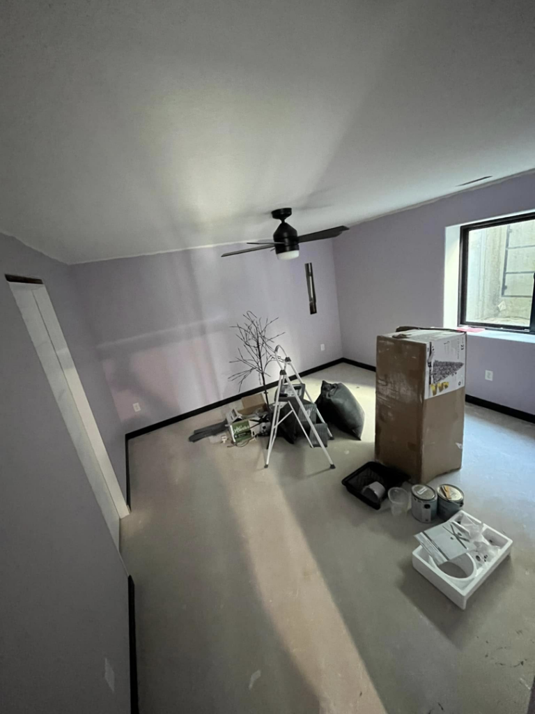 A room with a newly installed ceiling fan and light purple painted walls, indicating home improvement by Drew's Home Repair and Handyman Service in Wichita, KS.