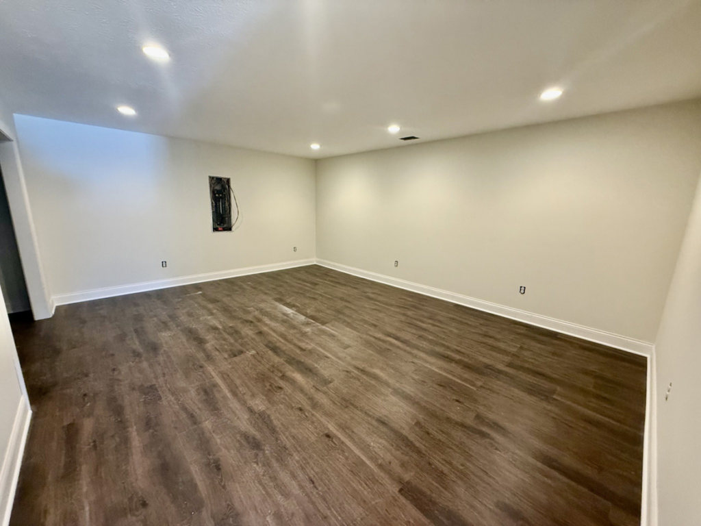 A renovated room featuring new flooring and an electrical panel, showcasing handyman work by Phillips Homes, LLC in Elizabethtown, KY.