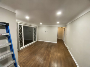 An empty room featuring new hardwood flooring and freshly painted walls, completed by Hazelton Services Inc in Warren, MI.