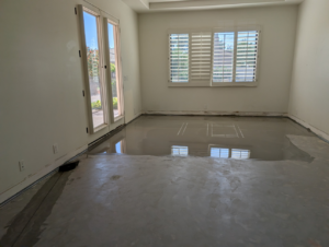 A room with newly applied self-leveling compound on the floor by Prestwick Custom Homes in Gilbert, AZ