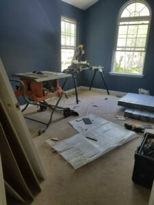 A room with power tools and flooring materials ready for installation by JMQ Contractor INC in Philadelphia, PA