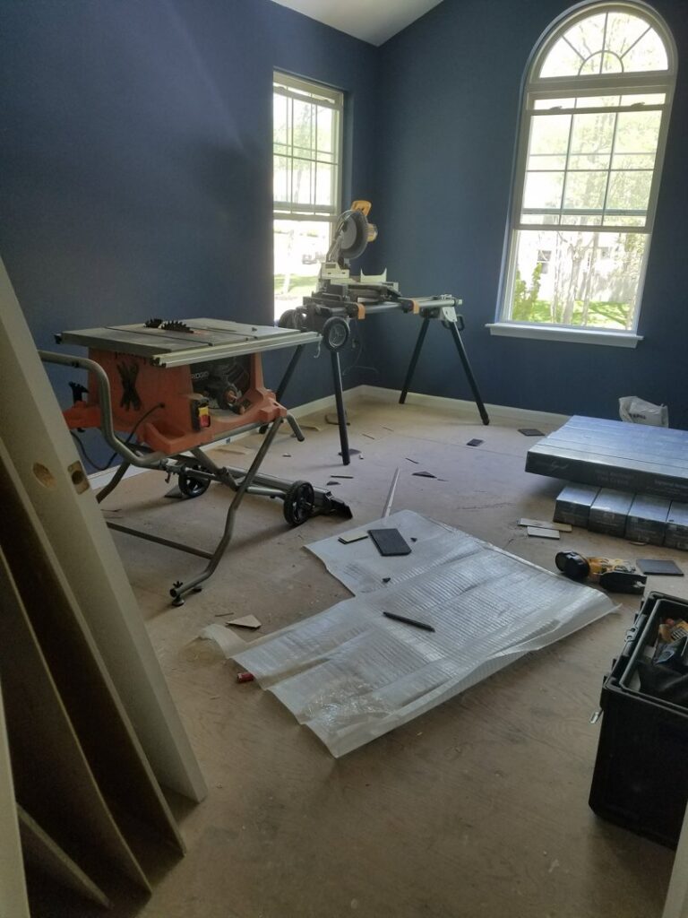 A room with power tools and flooring materials ready for installation by JMQ Contractor INC in Philadelphia, PA