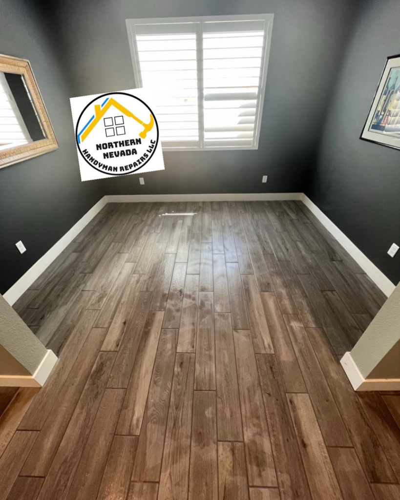 A room with newly installed wood-look tile flooring and baseboards by Northern Nevada Handyman Repairs LLC in Reno, NV