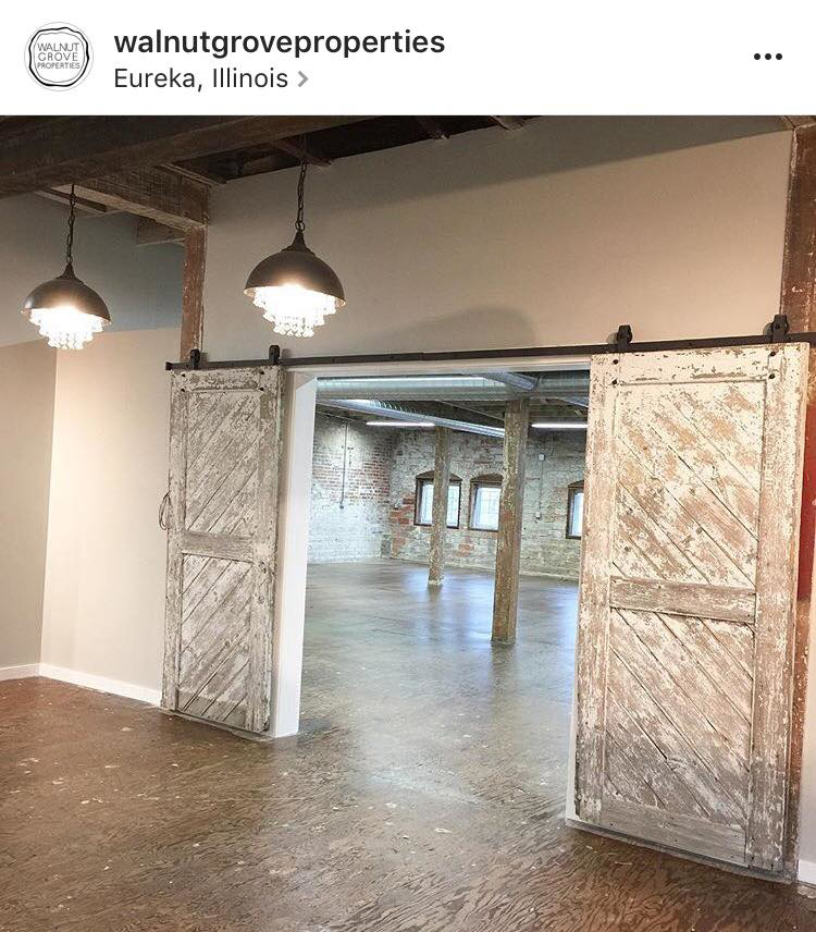 Large rustic barn doors opening into a commercial renovation project by Failsafe Electric, Inc. in Metamora, IL.