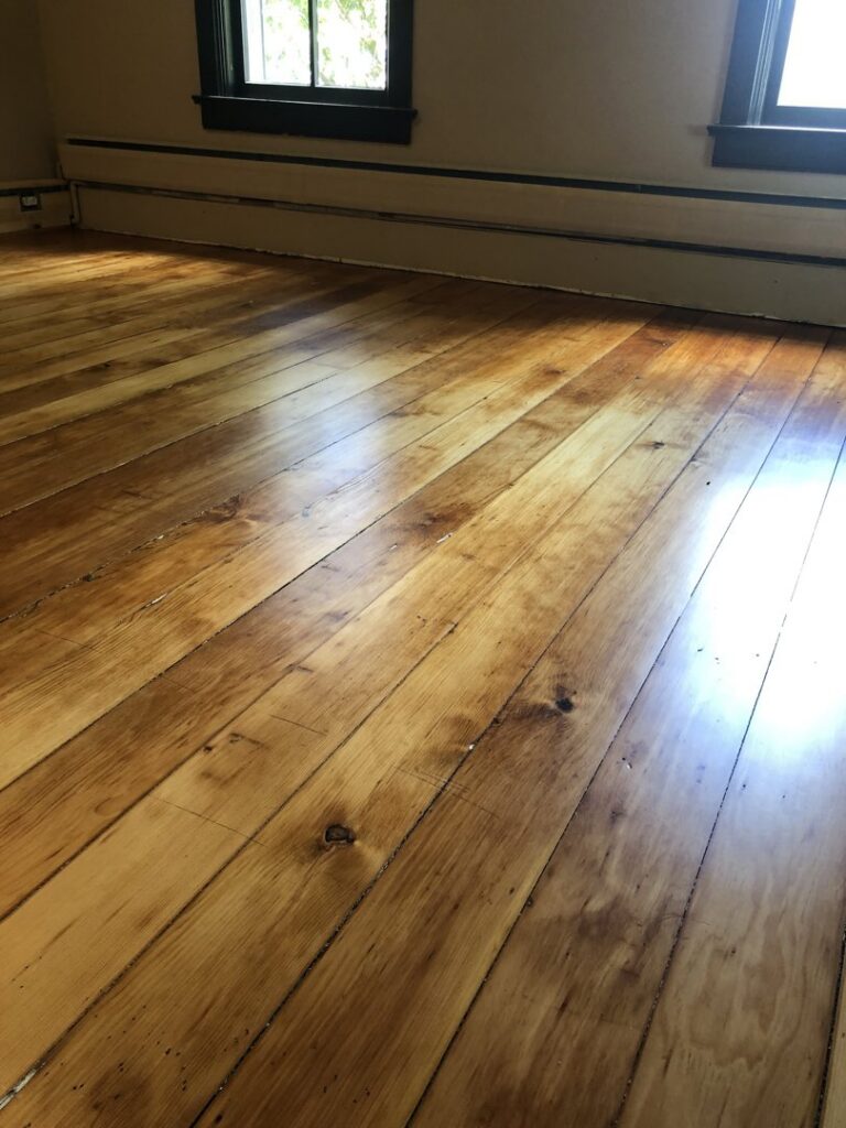 Close-up of a beautifully refinished rustic hardwood floor by Nelson Hardwood Flooring, highlighting its unique character in Madison, WI.
