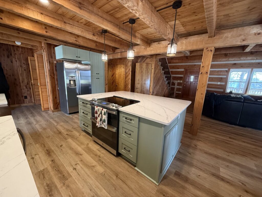 A completed rustic kitchen renovation with light green cabinets and a large island by Contractor Kev LLC in Winston-Salem, NC