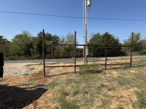 A rustic wire fence with sturdy metal posts installed for a rural property by Herron Fencing LLC in Shawnee, OK.