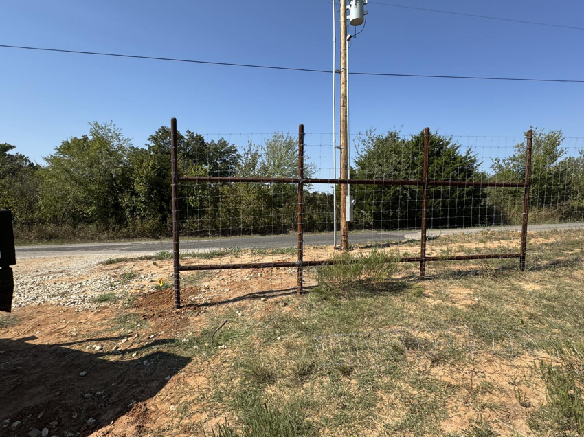 A rustic wire fence with sturdy metal posts installed for a rural property by Herron Fencing LLC in Shawnee, OK.