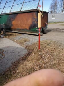 A large, rusty green roll-off dumpster, a common sight for junk removal and waste disposal services from Alaska Waste in Anchorage, AK.