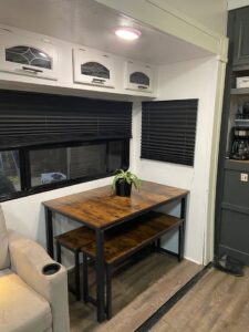 A renovated RV dining area with a custom table and benches, completed by The Sioux Falls Handyman in Sioux Falls, SD.