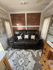 An RV interior with a decorative brick accent wall installed by Douglas Allstott Handyman Service in Horner, WV.
