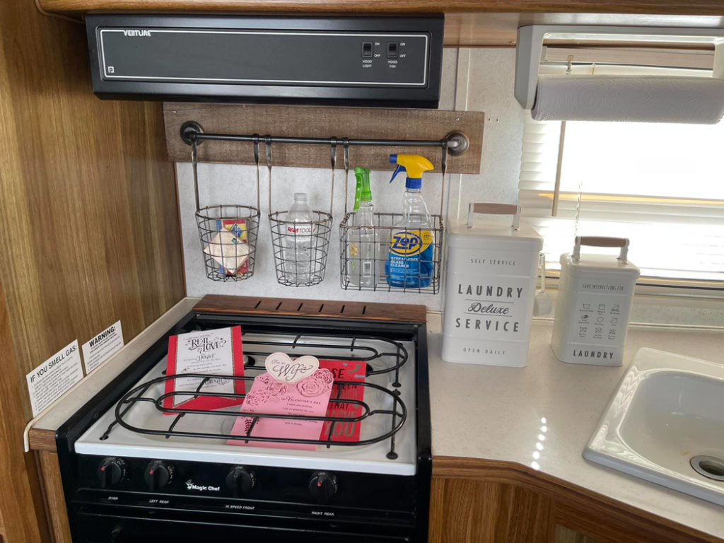 An RV kitchen with a newly installed hanging storage rack by Douglas Allstott Handyman Service in Horner, WV.