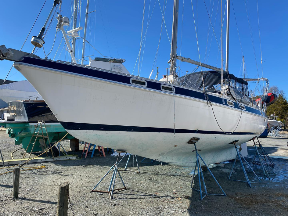 A sailboat hull showing marine growth before eco-blasting cleaning by Beach Eco Blasting in Virginia Beach, VA.