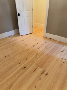 Sanded hardwood floor ready for staining, a handyman service by Trades by Taylor LLC in Huntsville, AL.