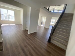 Stairs undergoing sanding and staining, with a sander tool visible, by IHS flooring LLC in Brighton, CO.