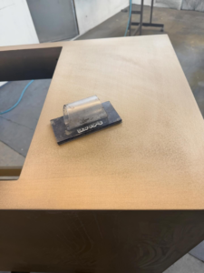 A sanding block on a cabinet surface during a finishing project by Bespoke Finish in Minneapolis, MN.