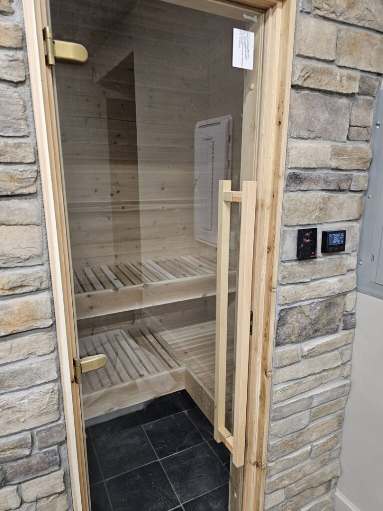 A newly installed sauna with a wooden interior and benches, completed by Jedi Bldrs in Colorado Springs, CO.