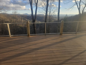 A scenic deck featuring cable railing and a mountain backdrop by American Cable & Rigging in Mills River, NC.