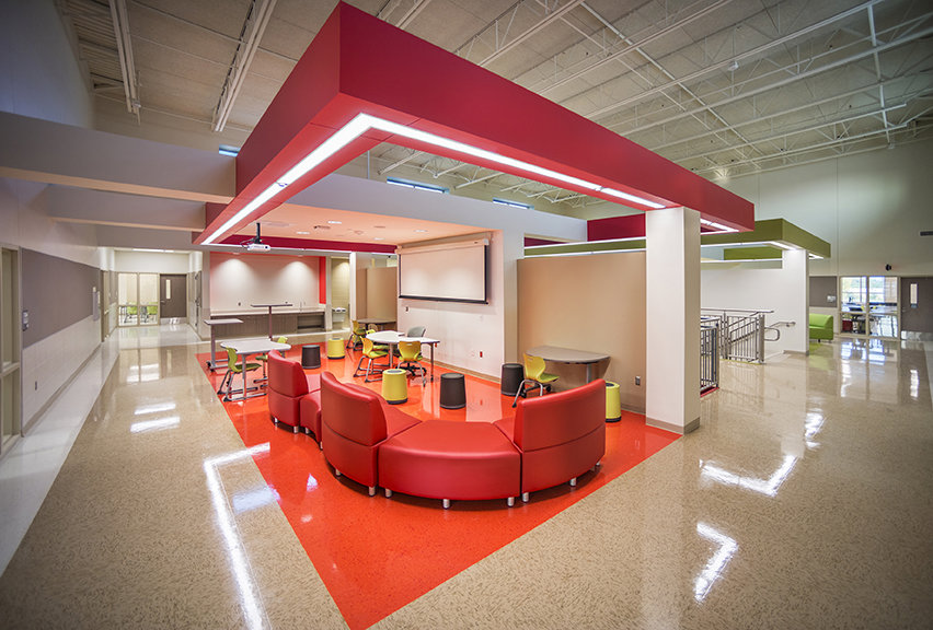 Interior view of a vibrant school common area with modern seating, completed by Reeder General Contractors, Inc. in Fort Worth, TX