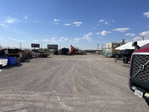 Piles of scrap metal and heavy machinery in the yard of FL Scrap in El Paso, TX, for general junk removal and recycling.