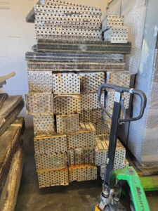 Large stack of scrap metal plates ready for recycling, managed by Jugganott Recycling, LLC in Orlando, FL.