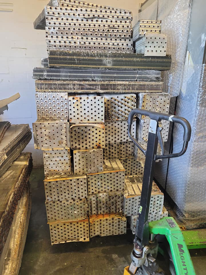 Large stack of scrap metal plates ready for recycling, managed by Jugganott Recycling, LLC in Orlando, FL.