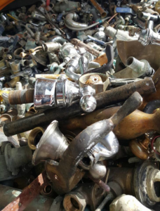 A close-up of various scrap metal plumbing fixtures collected for junk removal by MIM Metal Recycling in Los Angeles, CA.