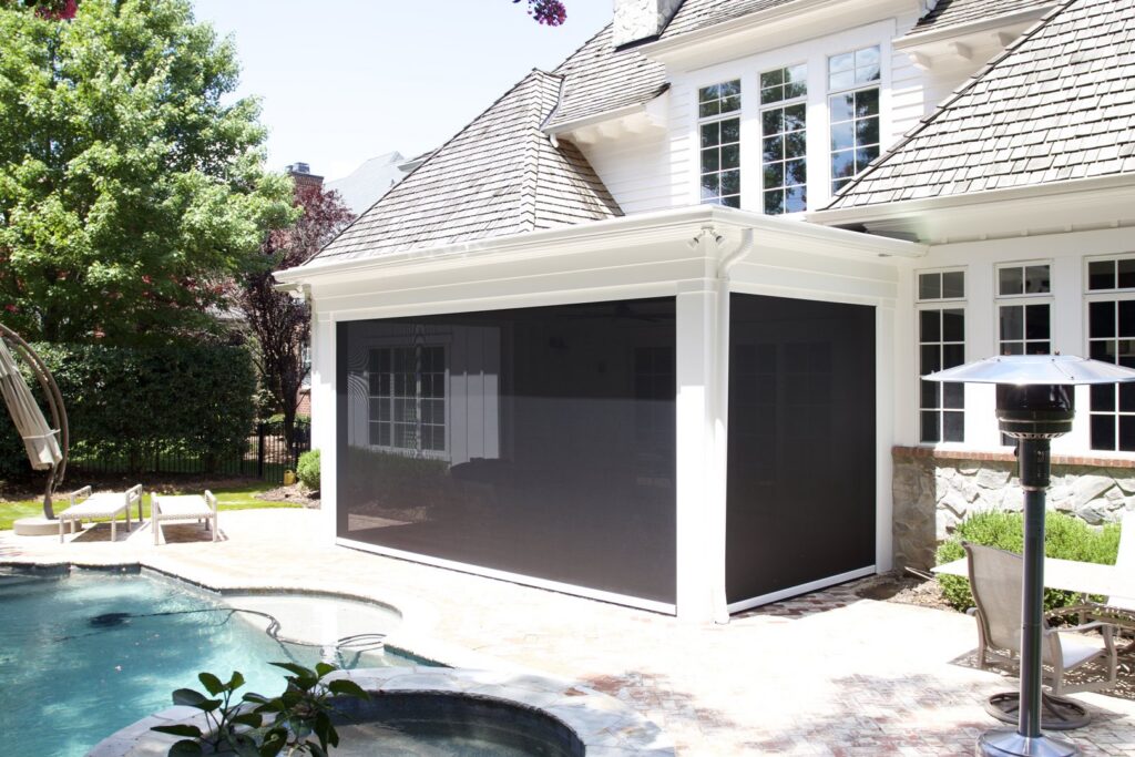 A stylish screened enclosure providing shade and comfort next to a swimming pool, installed by Screen Enc in Denver, NC